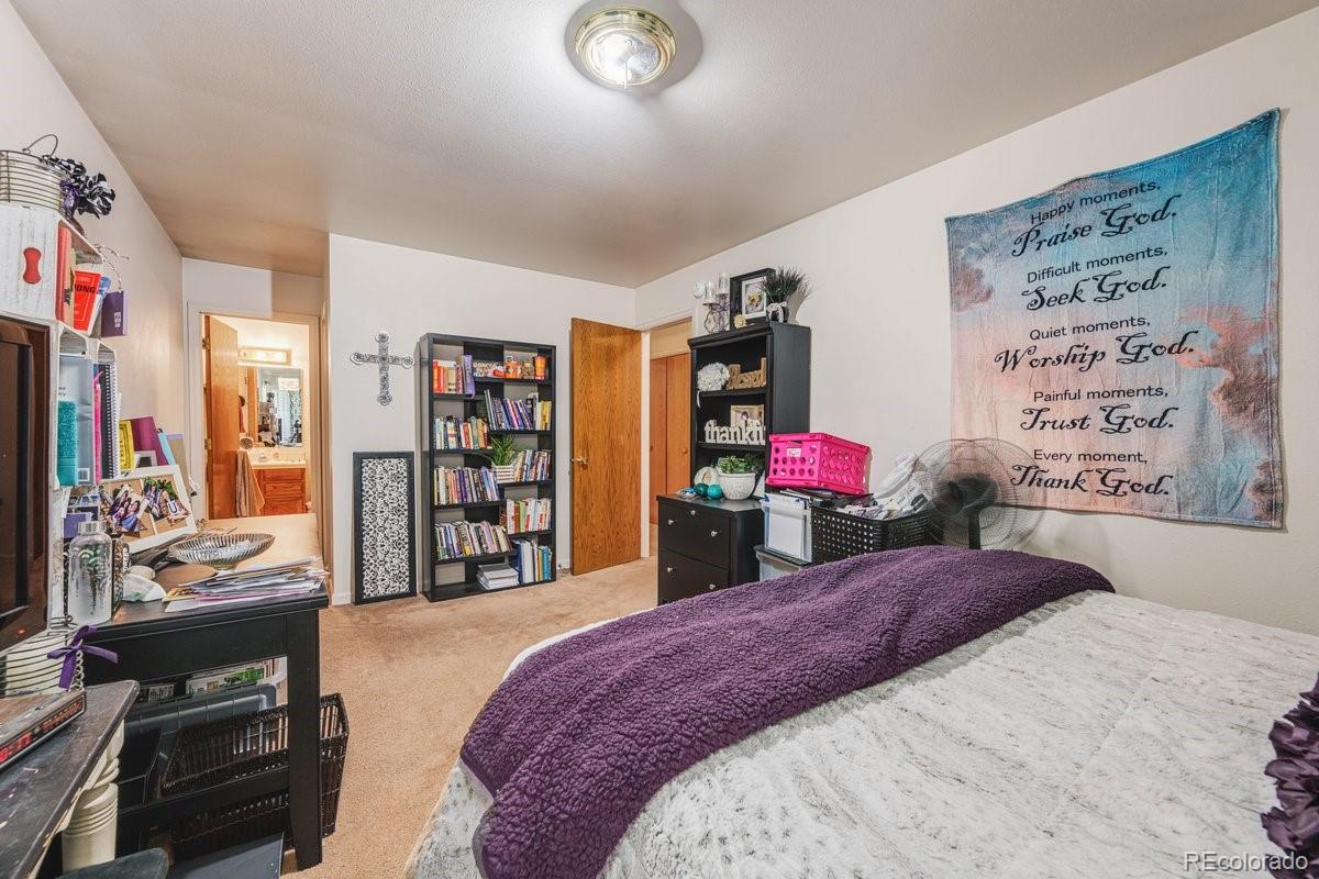 2166 35th Ave Court, Unit 14 Greeley, CO 80634 - Photo 18 of 33 a bedroom with a bed and closet