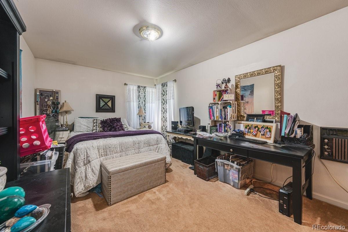 2166 35th Ave Court, Unit 14 Greeley, CO 80634 - Photo 19 of 33 a bed room with a bed and furniture