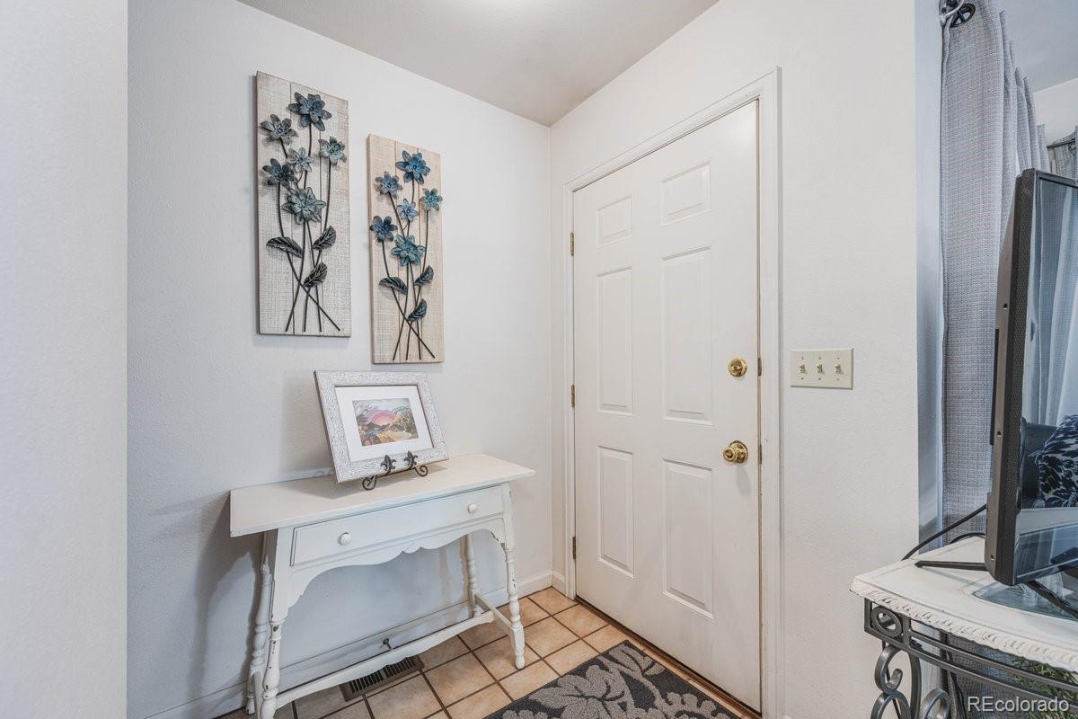 2166 35th Ave Court, Unit 14 Greeley, CO 80634 - Photo 7 of 33 a room with a table and a mirror