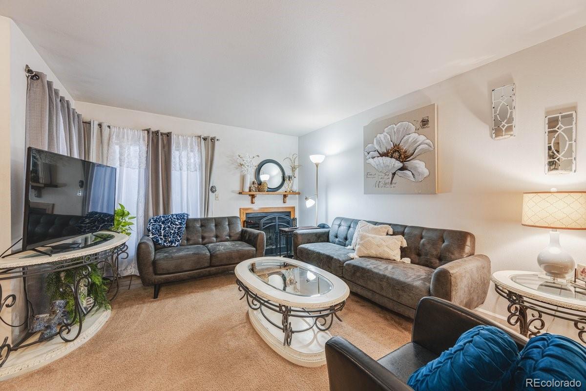 2166 35th Ave Court, Unit 14 Greeley, CO 80634 - Photo 8 of 33 a living room with furniture and a flat screen tv