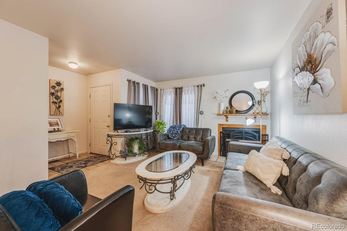 2166 35th Ave Court, Unit 14 Greeley, CO 80634 - Photo 10 of 33 a living room with furniture and a wooden floor