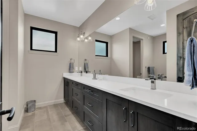 a bathroom with a double vanity sink mirror and