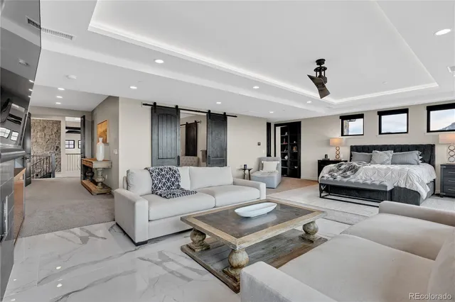 a bedroom with furniture and a chandelier