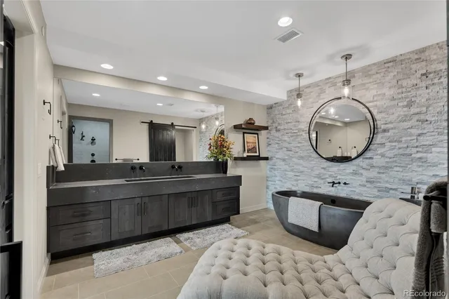 a large bathroom with a large tub sink and mirror