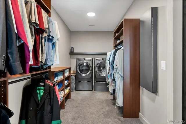 a view of walk in closet with clothes and shoes
