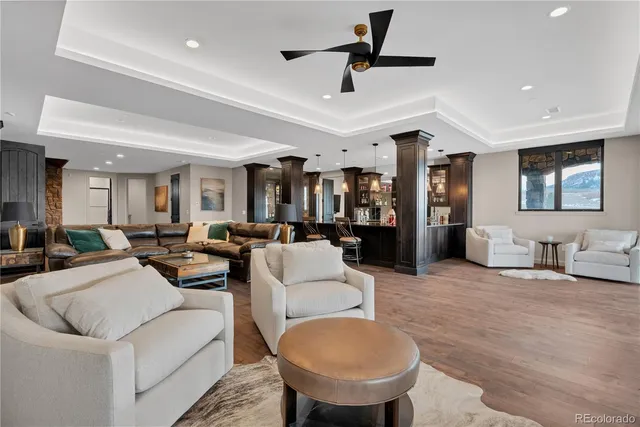 a living room with furniture and a wooden floor