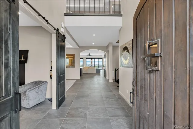 a view of a hallway with windows and stairs