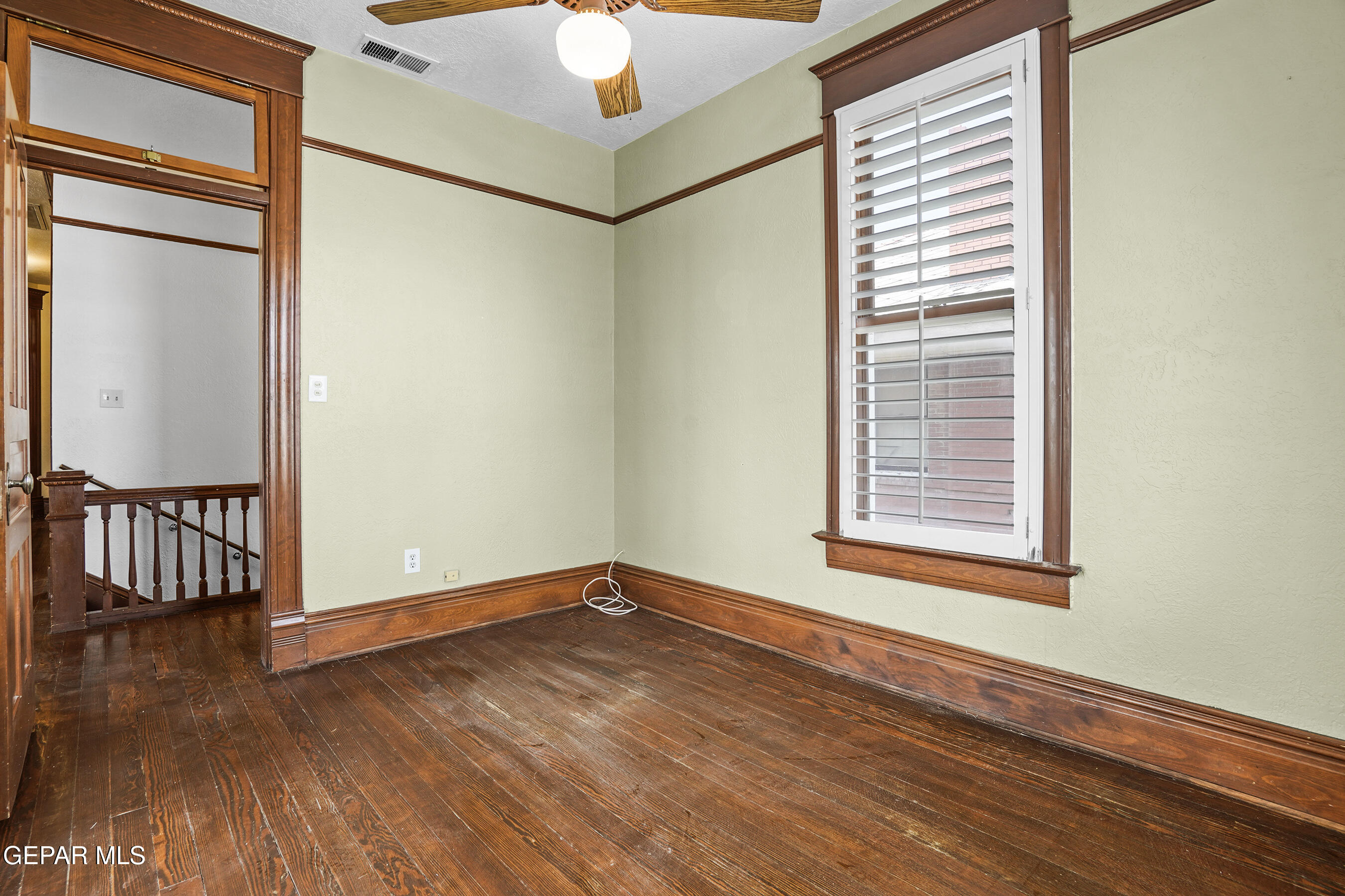1218 Prospect Street El Paso, TX 79902 - Photo 22 of 43 an empty room with wooden floor fan and windows
