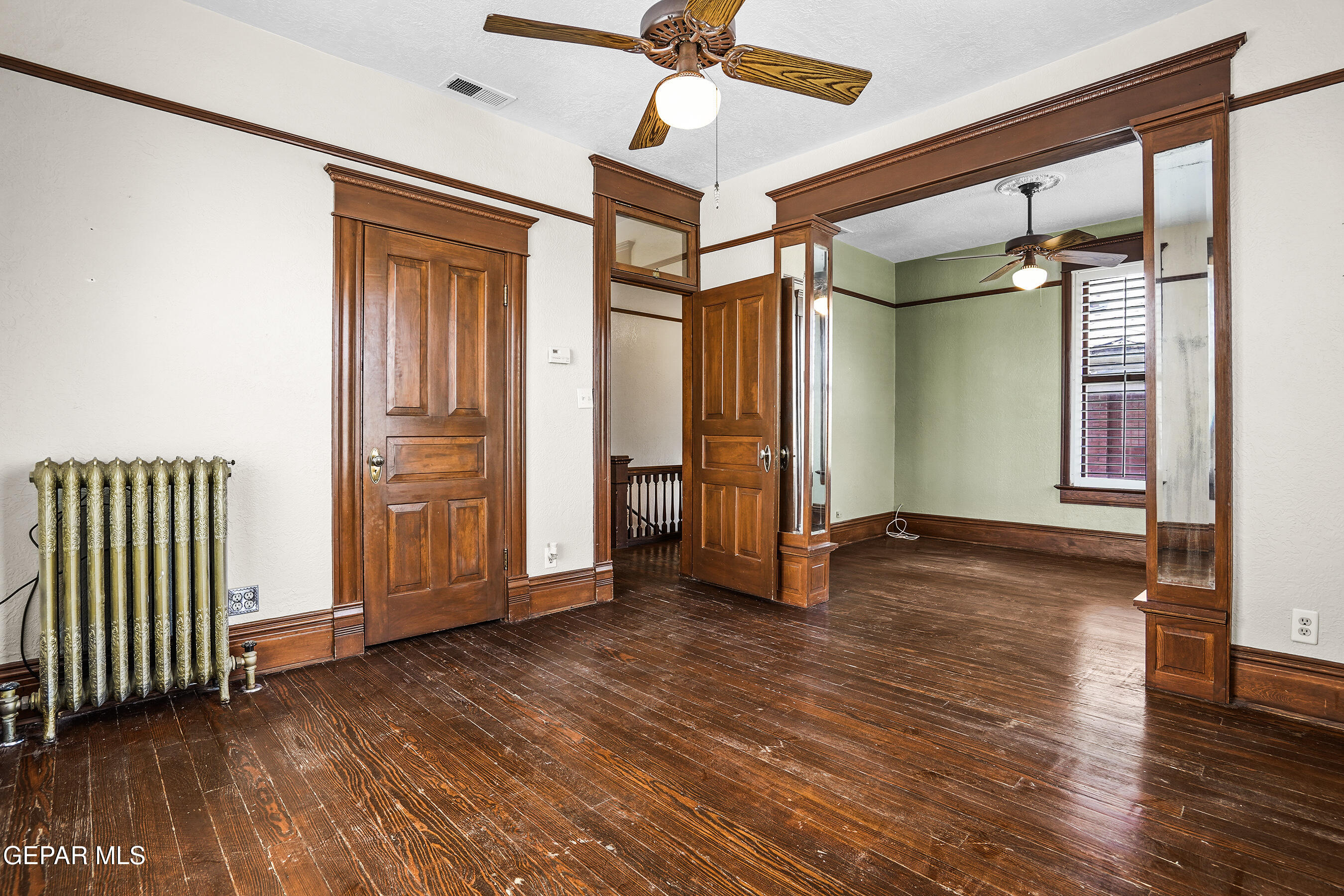 1218 Prospect Street El Paso, TX 79902 - Photo 23 of 43 an empty room with wooden floor door and windows