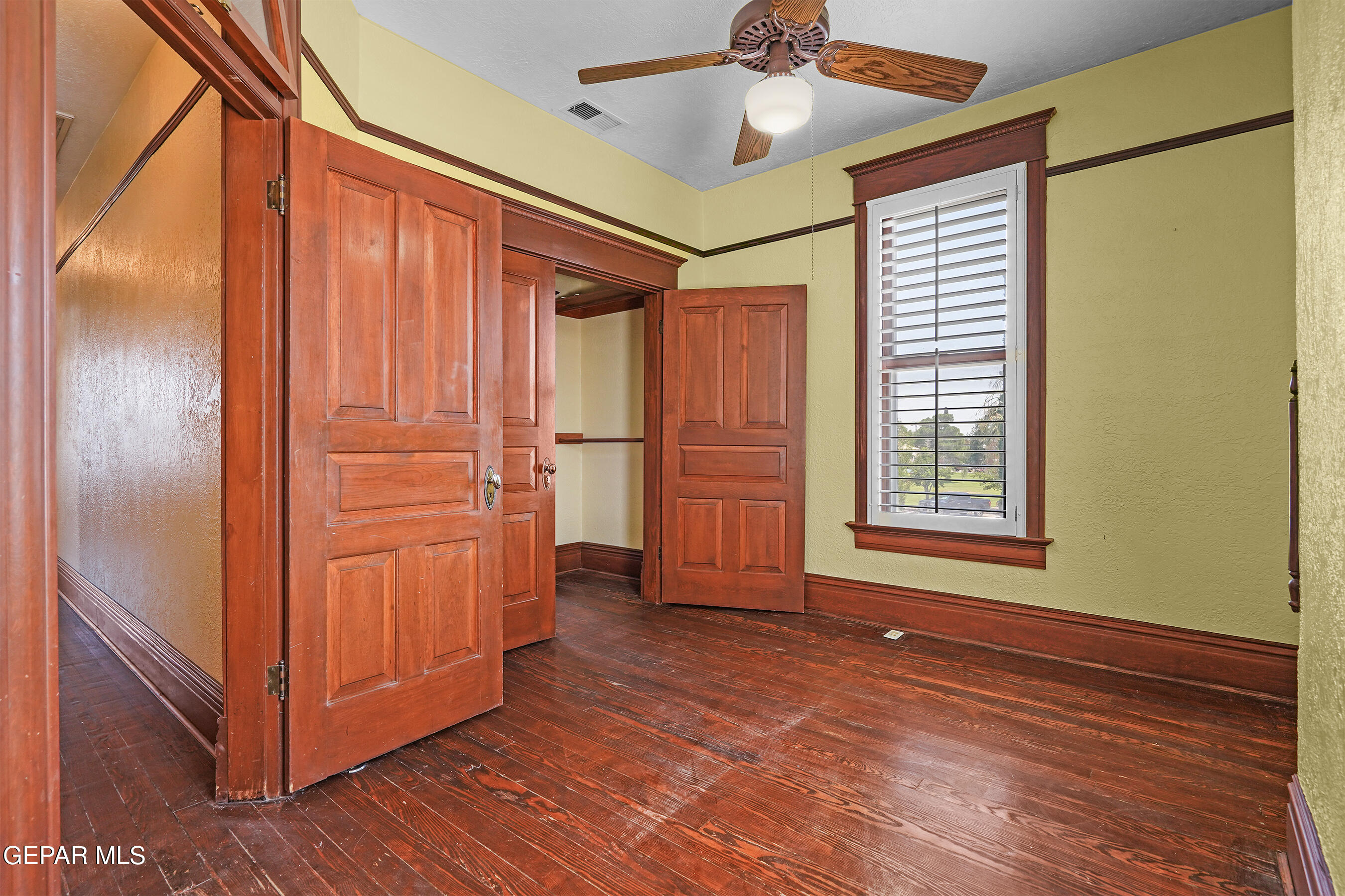 1218 Prospect Street El Paso, TX 79902 - Photo 29 of 43 an empty room with wooden floor closet and windows