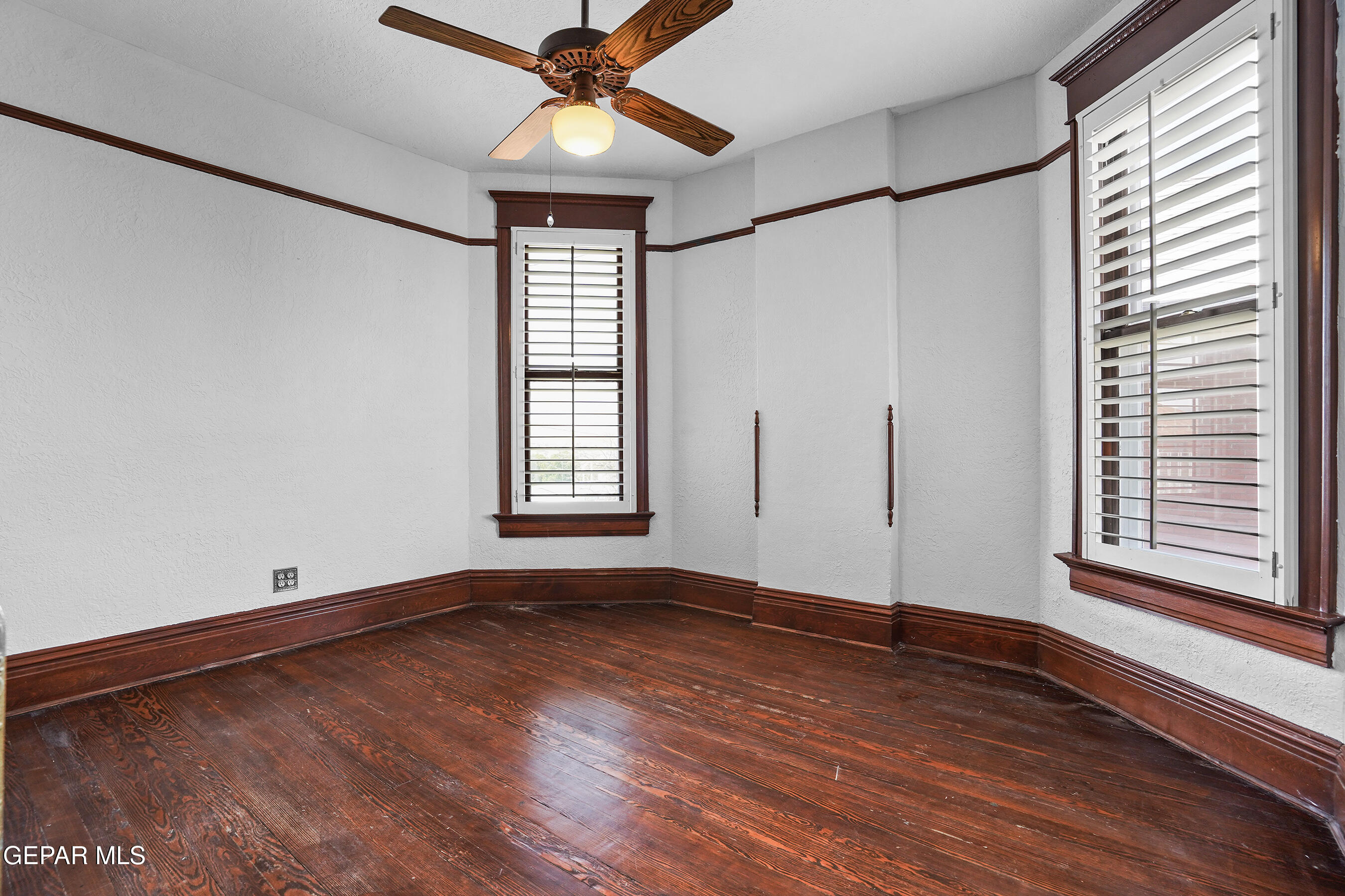 1218 Prospect Street El Paso, TX 79902 - Photo 31 of 43 an empty room with wooden floor fan and windows