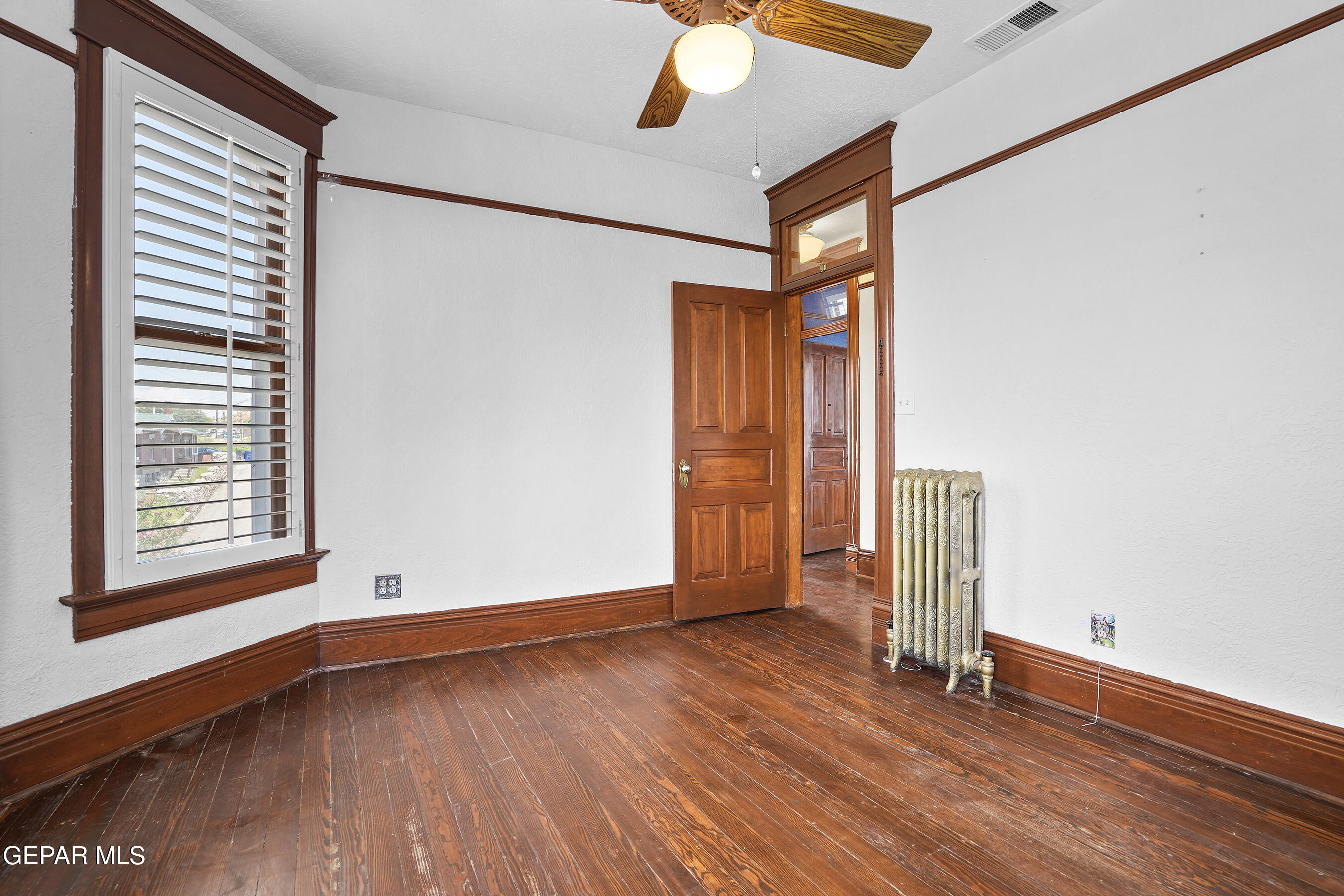 1218 Prospect Street El Paso, TX 79902 - Photo 32 of 43 a view of an empty room with wooden floor and a window