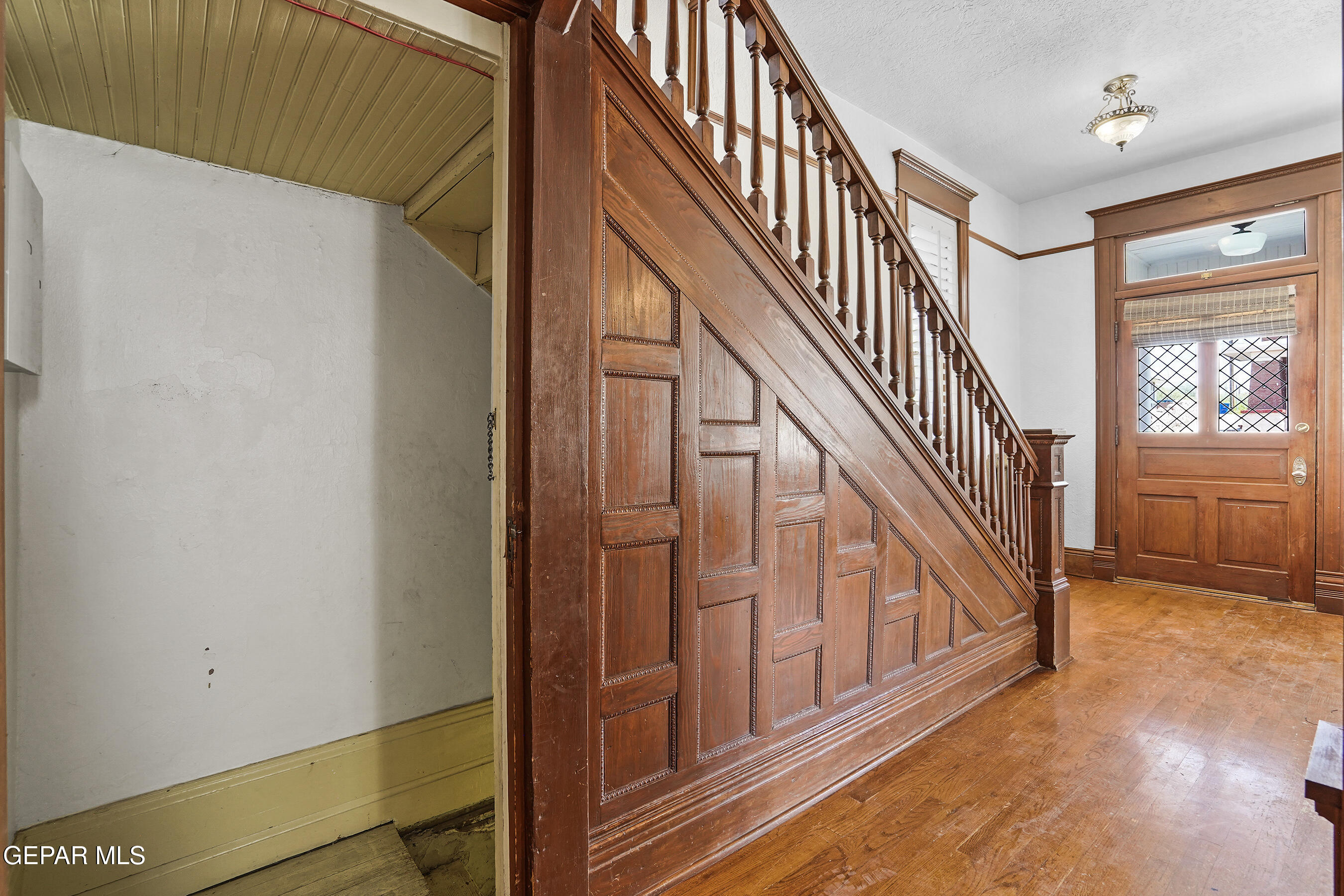 1218 Prospect Street El Paso, TX 79902 - Photo 6 of 43 a view of staircase with lots of frames on wall and windows