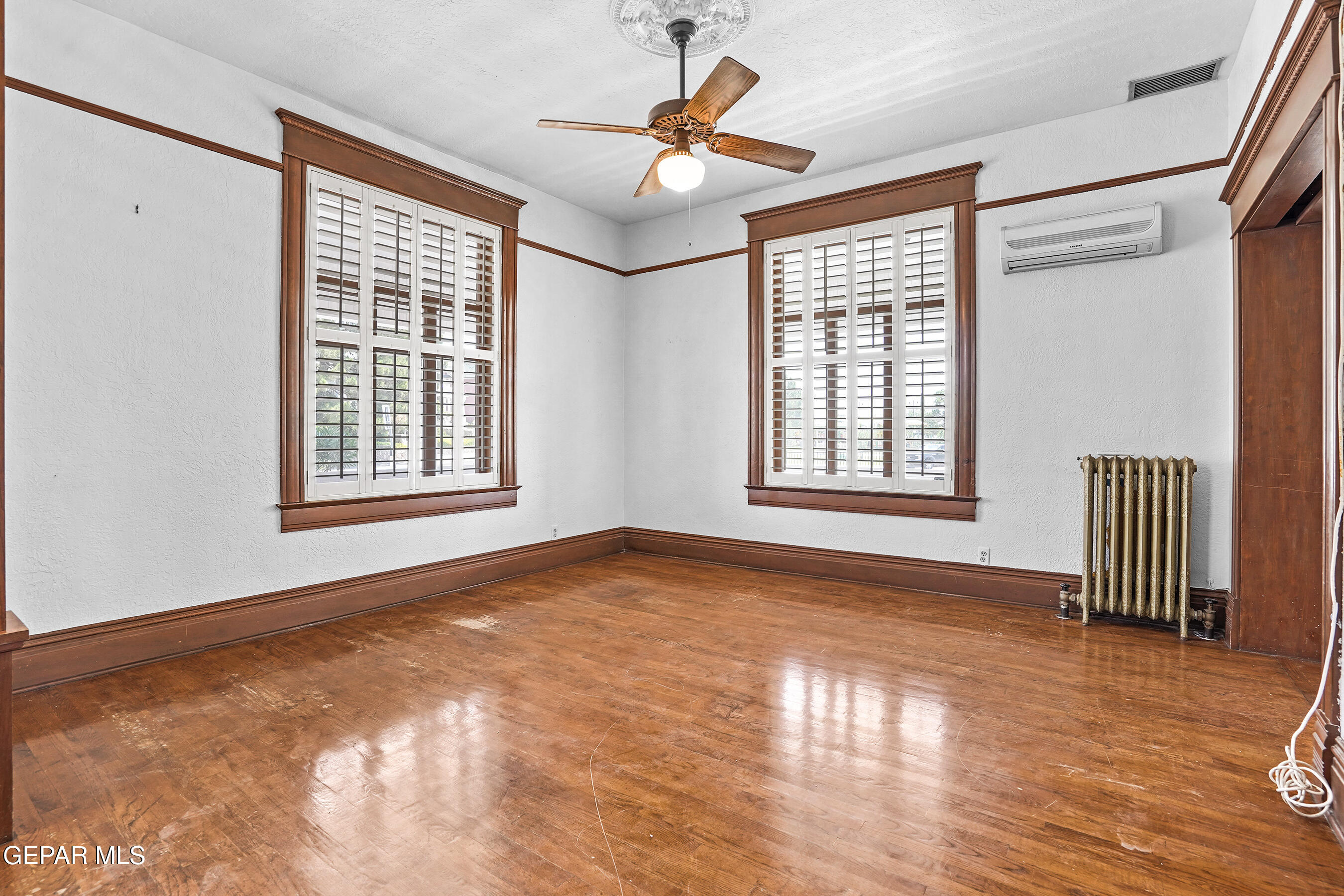 1218 Prospect Street El Paso, TX 79902 - Photo 7 of 43 a view of an empty room with a window and wooden floor