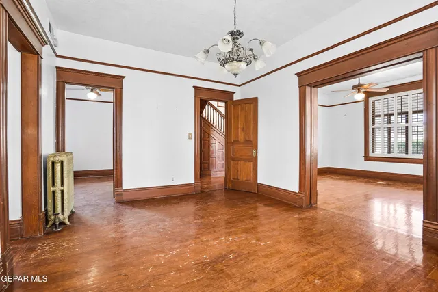 a kitchen with stainless steel appliances granite countertop a stove a sink and a refrigerator with white cabinets