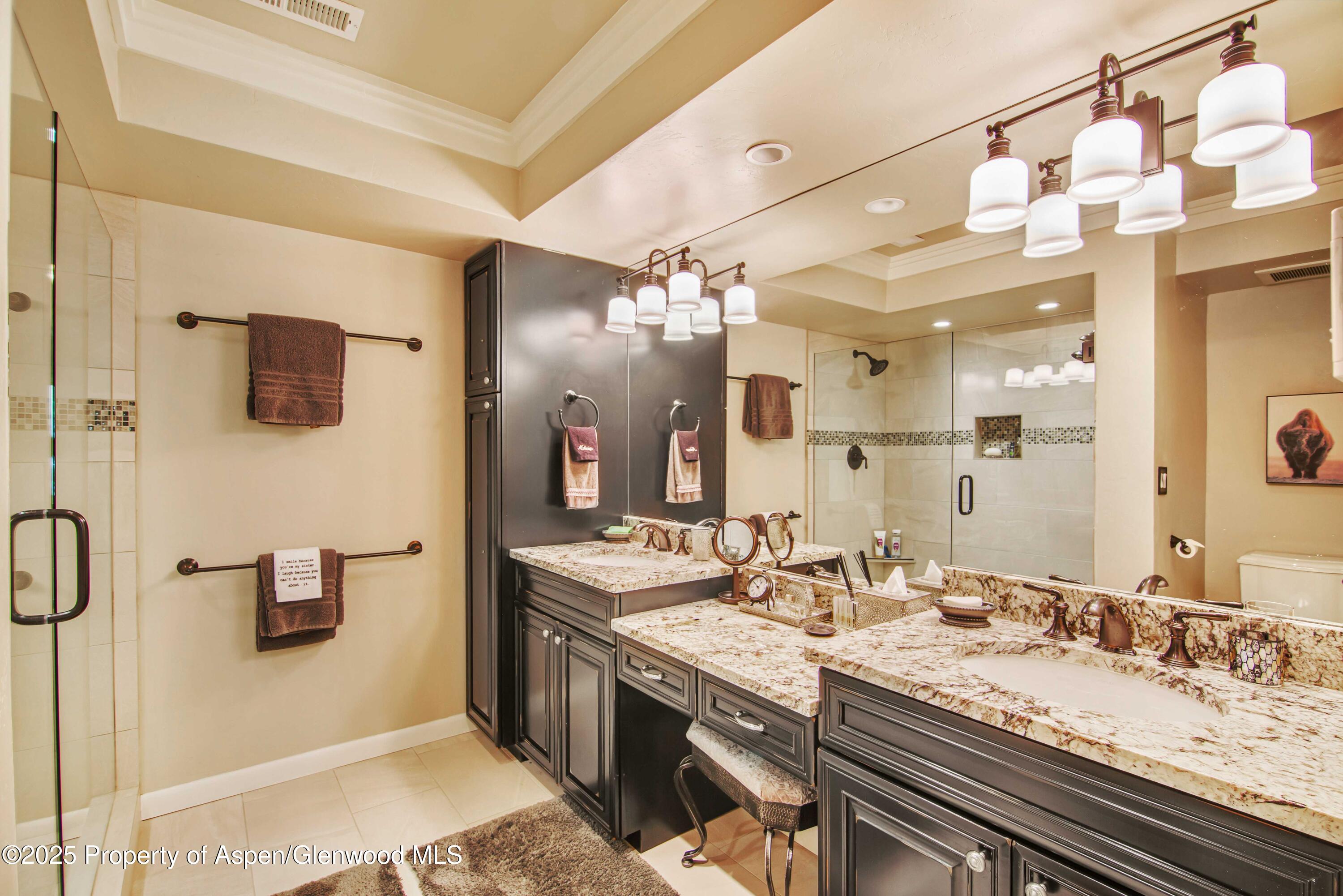 1637 Emma Spur Basalt, CO 81621 - Photo 32 of 45 a bathroom with a granite countertop double vanity sink a mirror and shower