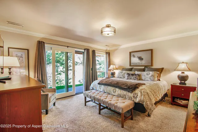 a spacious bedroom with a bed and a large window