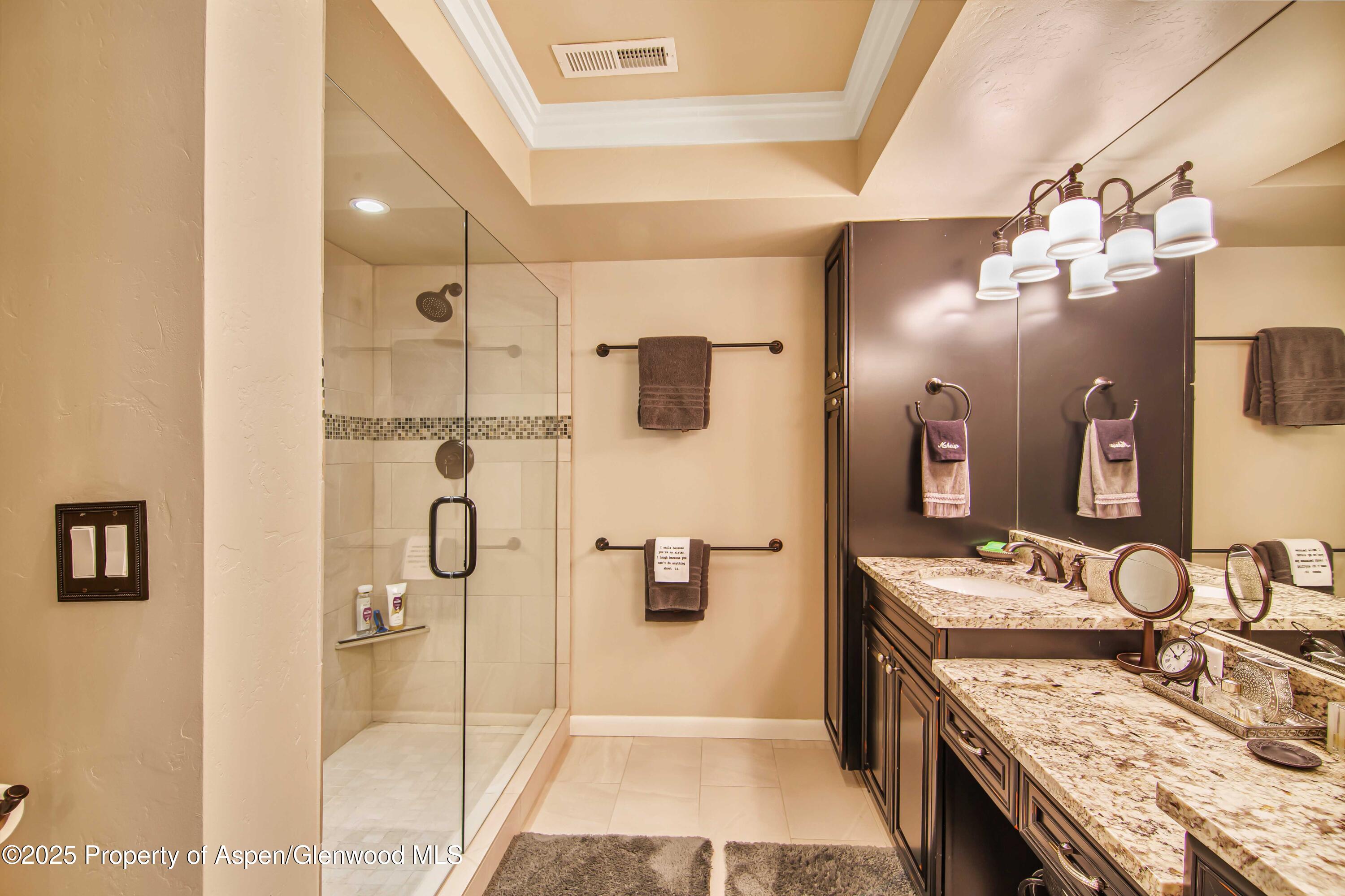 1637 Emma Spur Basalt, CO 81621 - Photo 33 of 45 a bathroom with a granite countertop sink a mirror and shower