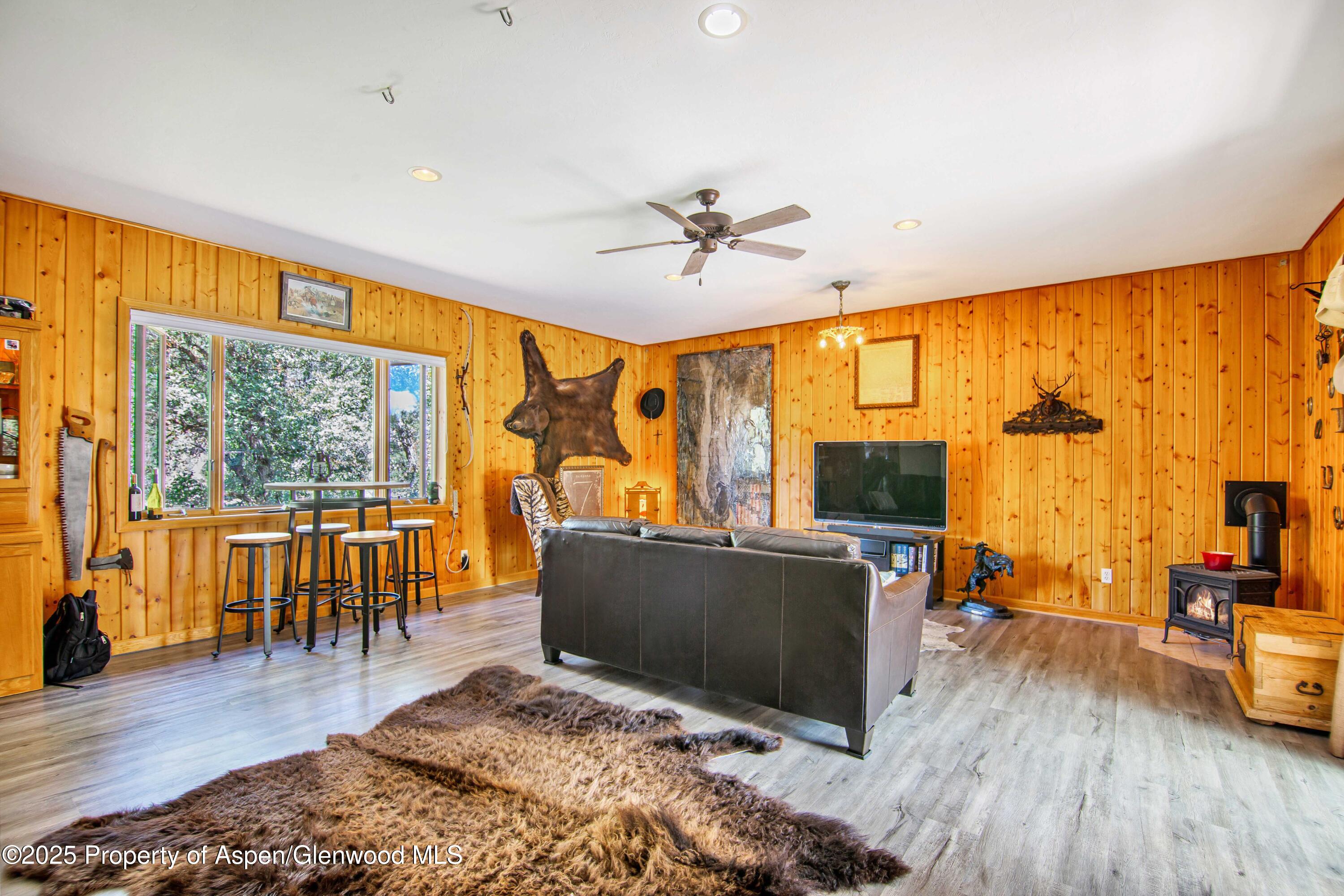 1637 Emma Spur Basalt, CO 81621 - Photo 36 of 45 a living room with furniture a flat screen tv and a floor to ceiling window or wooden floor