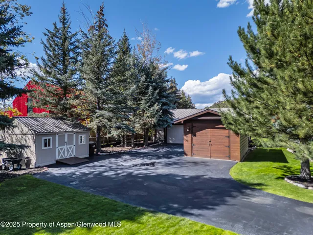 a front view of a house with a yard and a garage