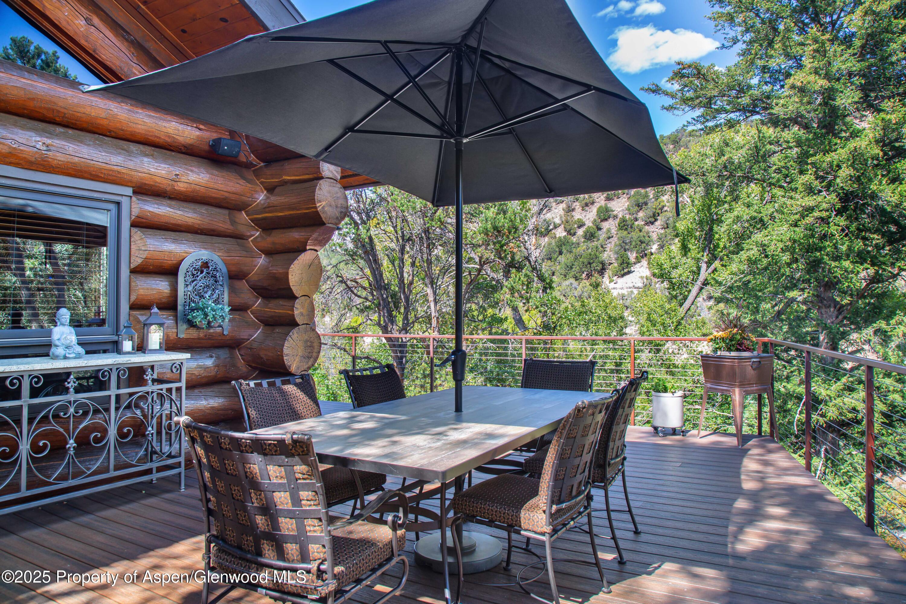 1637 Emma Spur Basalt, CO 81621 - Photo 5 of 45 a patio with wooden floor a yard a table and chairs