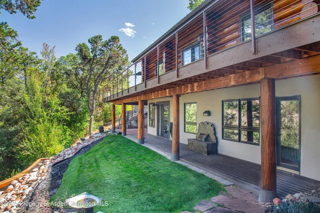 a view of a house with a yard balcony and a patio