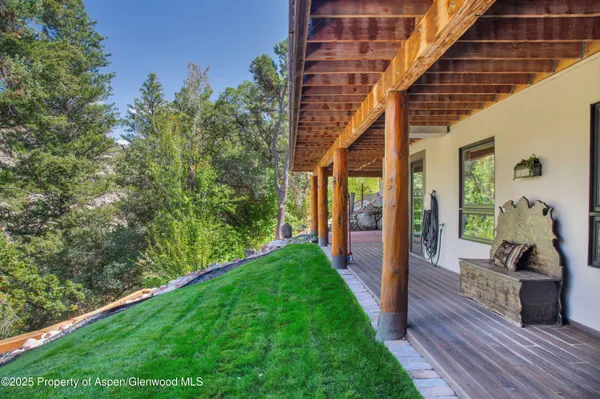 a bathroom with a granite countertop sink a large mirror and a shower