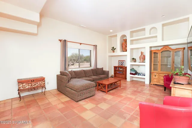 a living room with furniture and a dining table