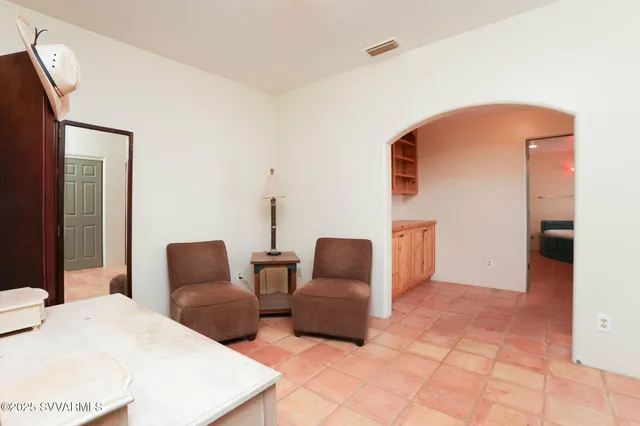 a living room with a couch and a potted plant