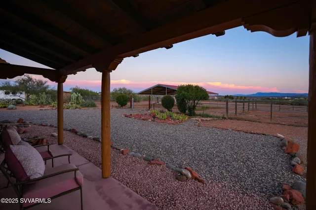 a view of a porch with furniture and garden