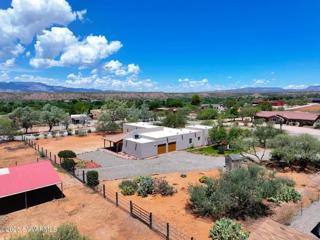 a dining hall with stainless steel appliances kitchen island granite countertop a table chairs and a refrigerator