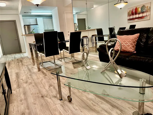 a dining room with furniture and wooden floor