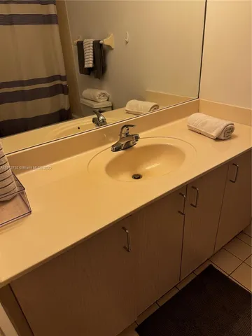 a bathroom with a sink and a mirror