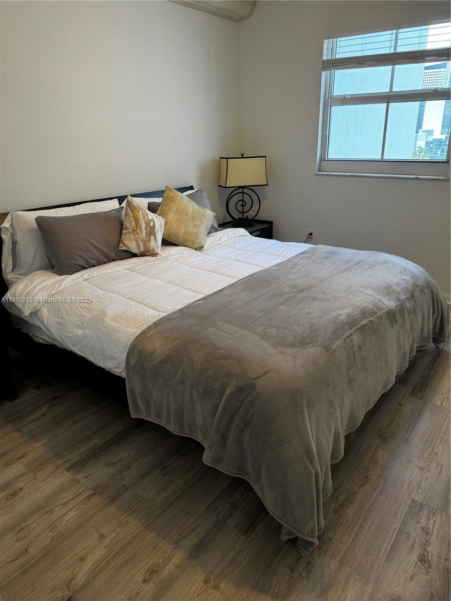 185 Southeast 14th Terrace, Unit 1812 Miami, FL 33131 - Photo 6 of 10 a bedroom with a bed and window