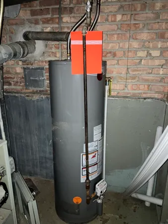 a room with water heater and storage racks
