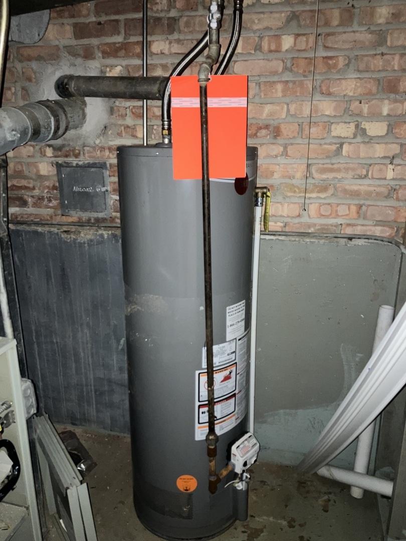 840 East 89th Street Chicago, IL 60619 - Photo 18 of 27 a room with water heater and storage racks