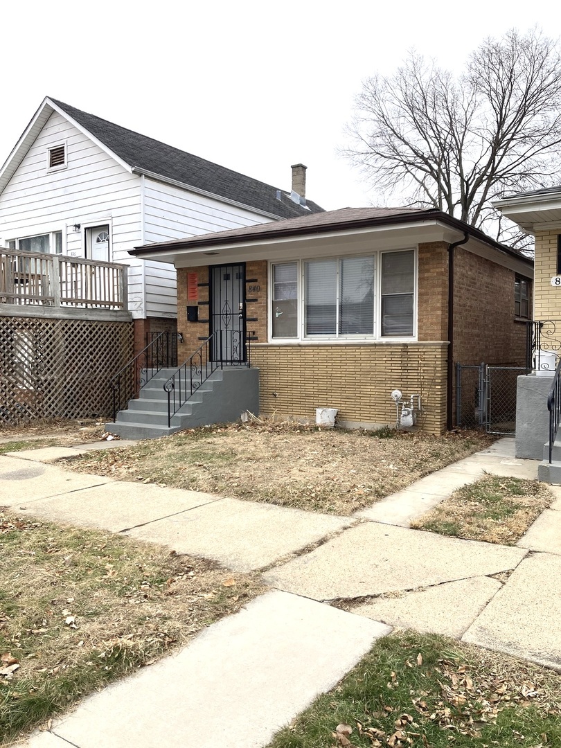 840 East 89th Street Chicago, IL 60619 - Photo 2 of 27 a front view of a house with a patio