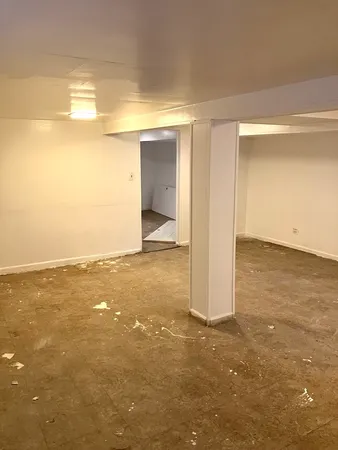 an empty room with a empty space and a window