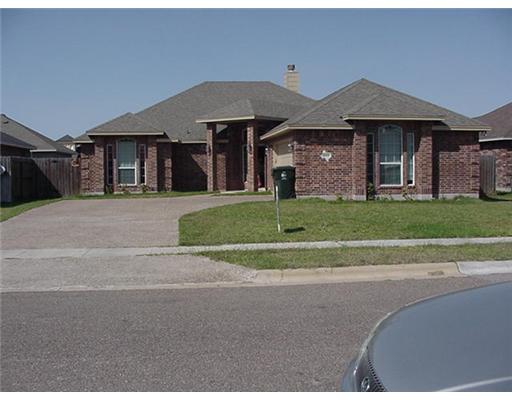 6850 Round Table Street Corpus Christi, TX 78414 - Photo 1 of 4 a front view of a house with a yard