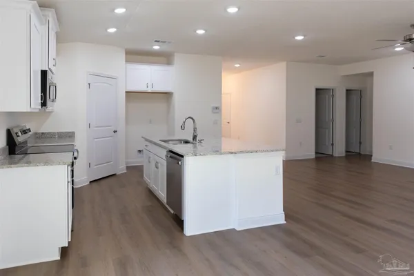 a kitchen with a sink a stove and a refrigerator