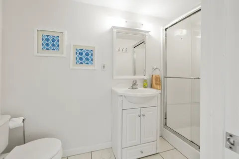 a bathroom with a sink a toilet and vanity