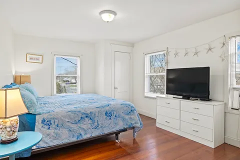 a bedroom with a bed and a flat screen tv