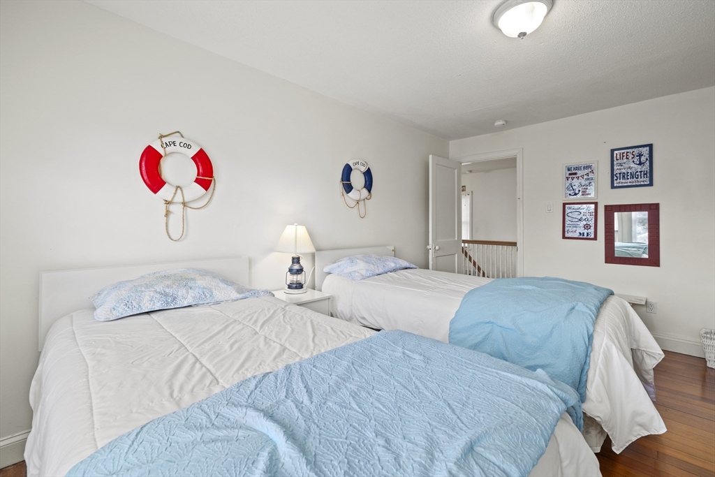 169 Gosnold Street Barnstable, MA 02601 - Photo 20 of 40 a bedroom with a bed and a lamp