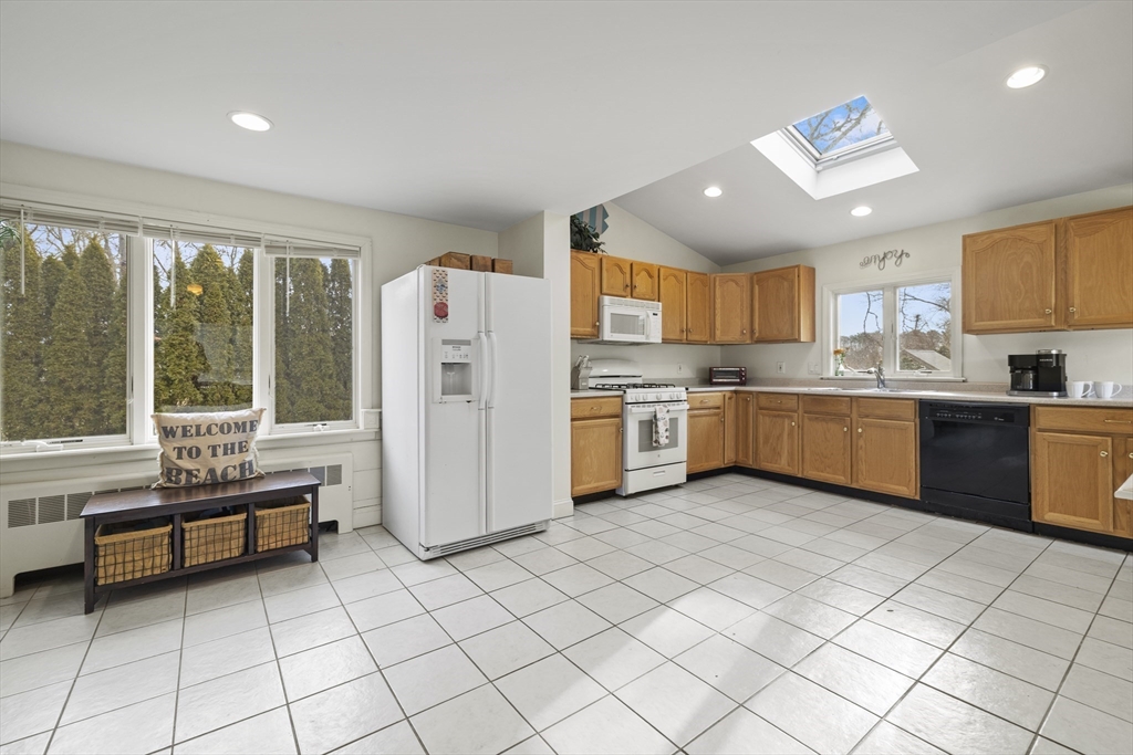 169 Gosnold Street Barnstable, MA 02601 - Photo 2 of 40 a kitchen with stainless steel appliances granite countertop a refrigerator sink and cabinets