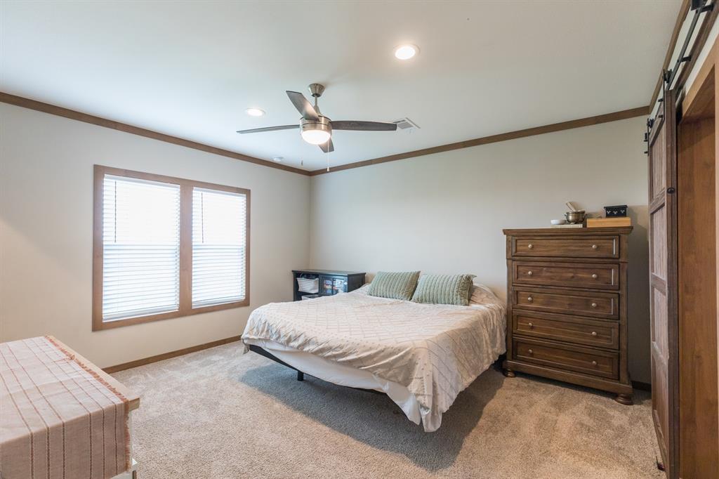 10099 County Road 452 Merkel, TX 79536 - Photo 11 of 28 a bedroom with a bed and a dresser