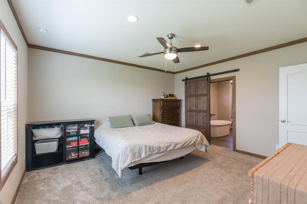 10099 County Road 452 Merkel, TX 79536 - Photo 12 of 28 a bedroom with a bed and a chandelier
