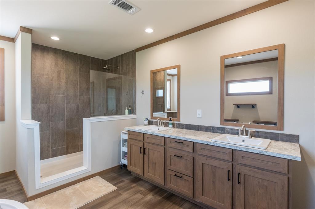 10099 County Road 452 Merkel, TX 79536 - Photo 15 of 28 a bathroom with 2 sink tub and a mirror