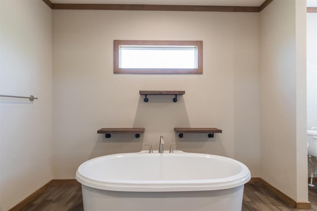10099 County Road 452 Merkel, TX 79536 - Photo 17 of 28 a bathroom with a sink and a bathtub