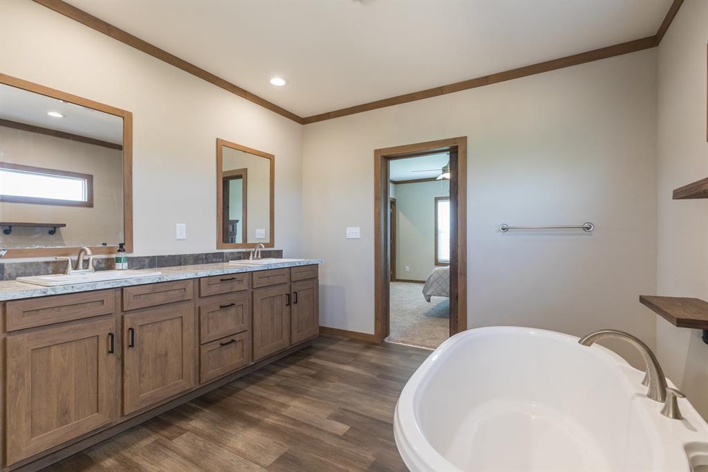 10099 County Road 452 Merkel, TX 79536 - Photo 18 of 28 a bathroom with a bathtub sink and mirror