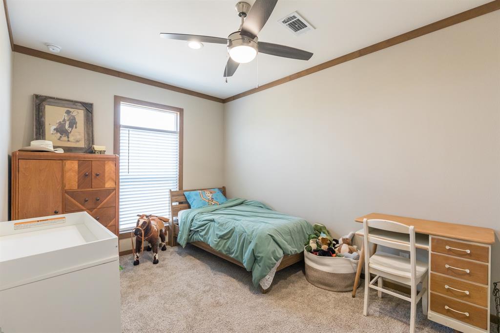 10099 County Road 452 Merkel, TX 79536 - Photo 19 of 28 a bedroom with a bed and a cabinets